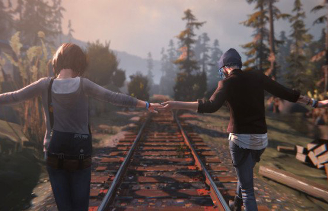 Two femme people balancing on railroad tracks, holding hands.