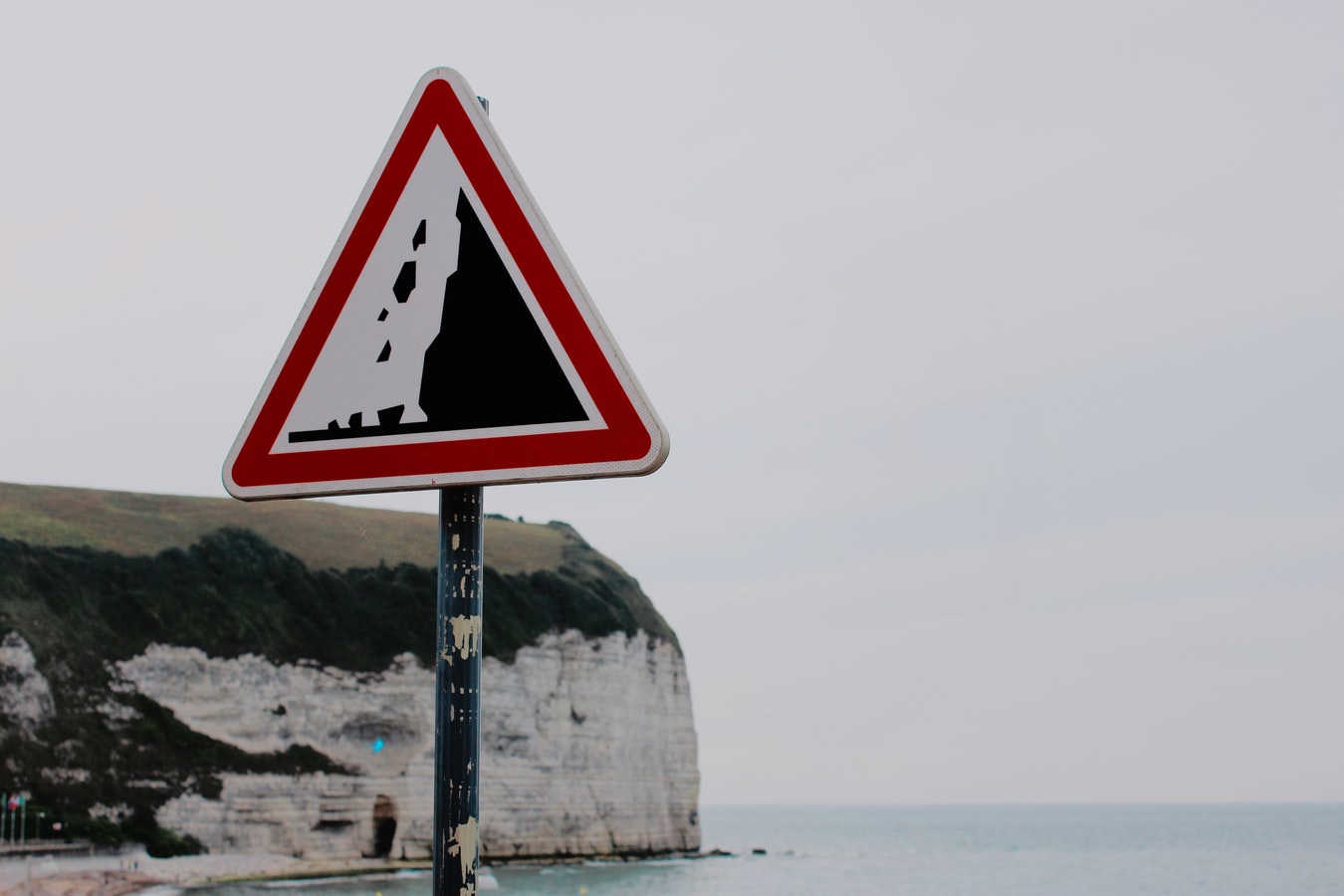 A cliff edge with a 'Warning' sign.